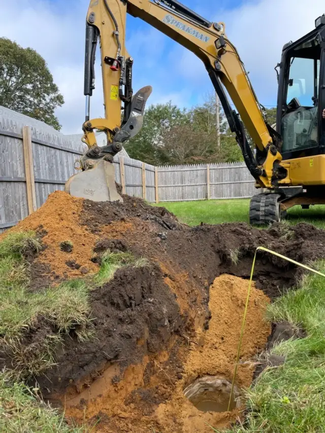 Excavator digging a soil test hole