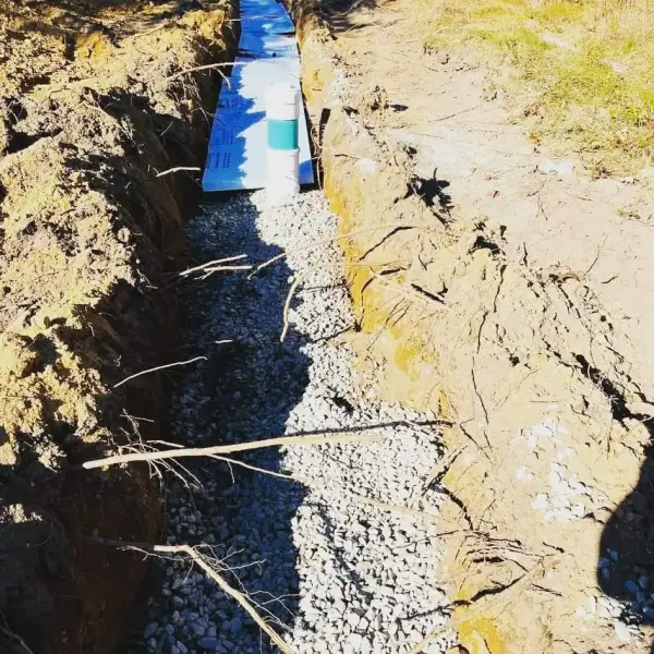 Pipe being set in a gravel trench